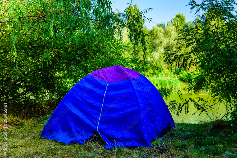 Blue tent in a forest on summer Blue tent in a forest on summer