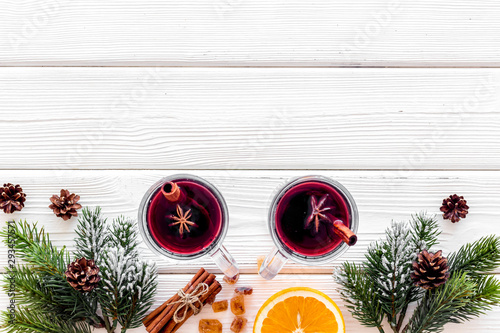 Background with mulled wine and New Year decoration on white wooden background top view frame space for text