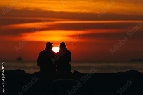 Fototapeta Naklejka Na Ścianę i Meble -  Silhouette of couple at sunset time