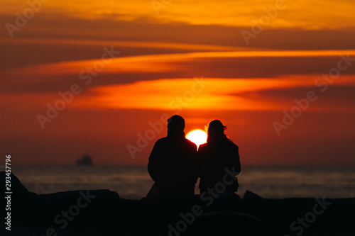 Silhouette of couple at sunset time