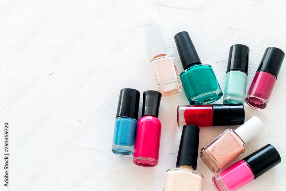Choose nail polish. Polish bottels on white background top view copy space Choose nail polish. Polish bottels on white background top view copy space