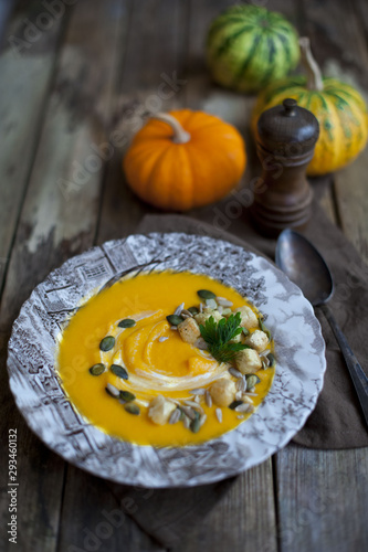 Creamy pumpkin soup topped with pumpkin 	