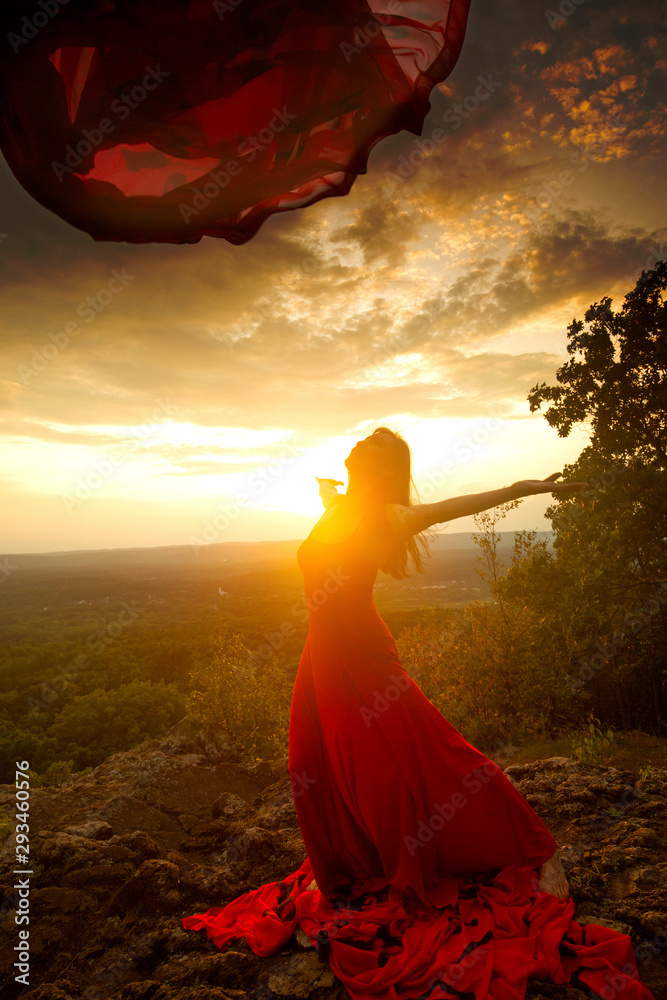 Dancer throwing red fabric into the wind in Connecticut.