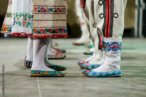 Close up of wool socks on legs of young Romanian female and male dancers in traditional folkloric costume. Folklore of Romania