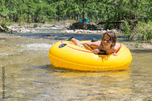 USA, Texas, Boy tubing the Frio River