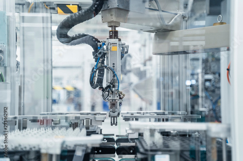 Arm of assembly robot functioning inside modern factory, Stuttgart, Germany photo