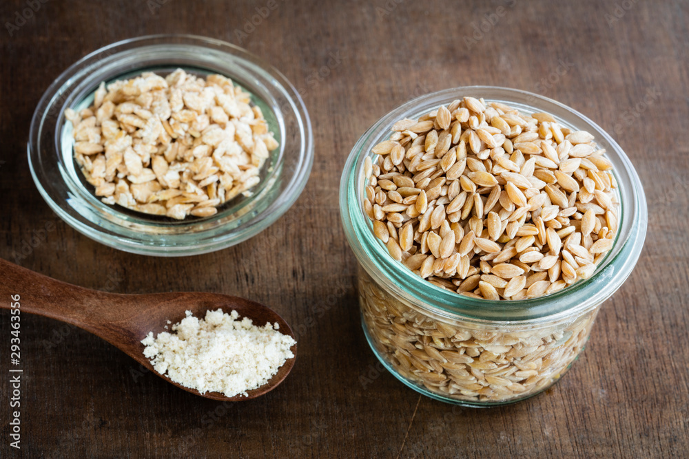 Ancient grains, Einkorn Wheat in glass jar as grain, flakes and flour Ancient grains, Einkorn Wheat in glass jar as grain, flakes and flour