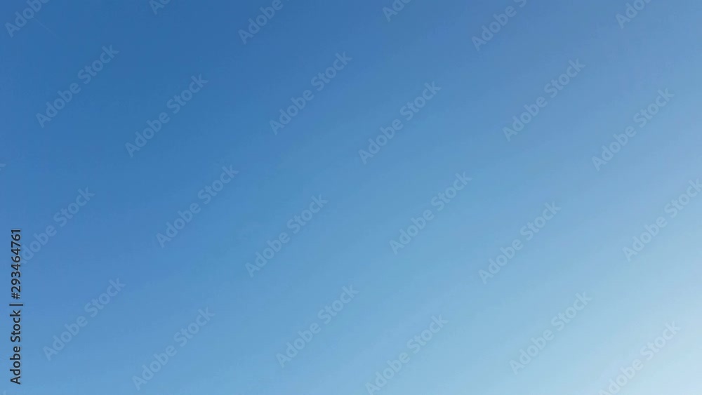 4k footage real time airplane flying in the clear blue sky at the right corner of the screen.  