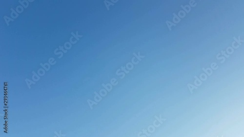 4k footage real time airplane flying in the clear blue sky at the right corner of the screen.  