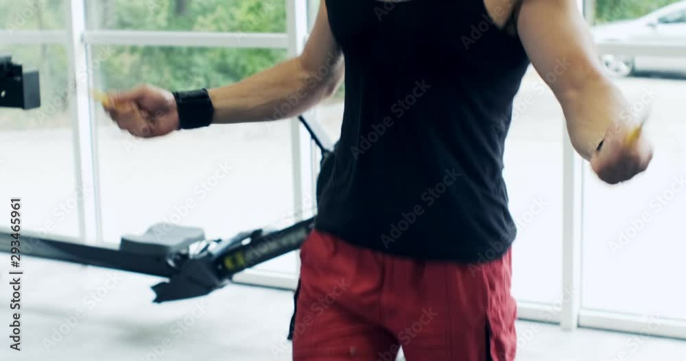 Athletic Man working out with a jump-rope. Close up, slow motion Athletic Man working out with a jump-rope. Close up, slow motion