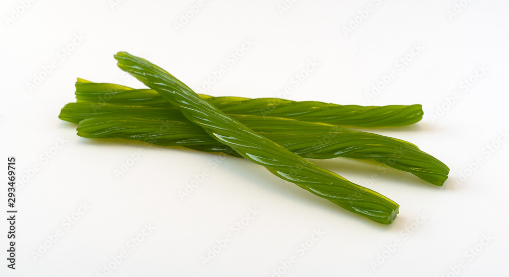 Several pieces of apple flavor licorice on a white background. Several pieces of apple flavor licorice on a white background.