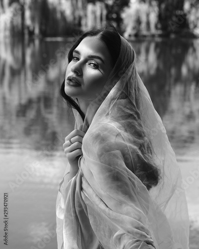 Beautiful girl with clean and pigmented skin on the nature on the lake