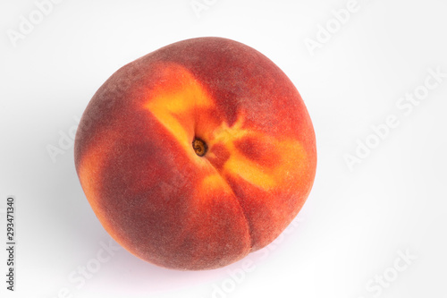 Close-up top view on one yellow and red organic peach