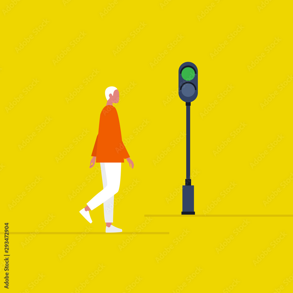 Green traffic light. Young male pedestrian crossing the road. Safety ...