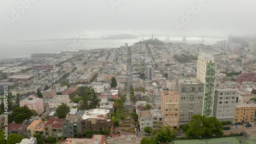 Beautiful aerial view of the cloudy San Francisco. Flying over the clouds near Lombard street with an amazing city view.  