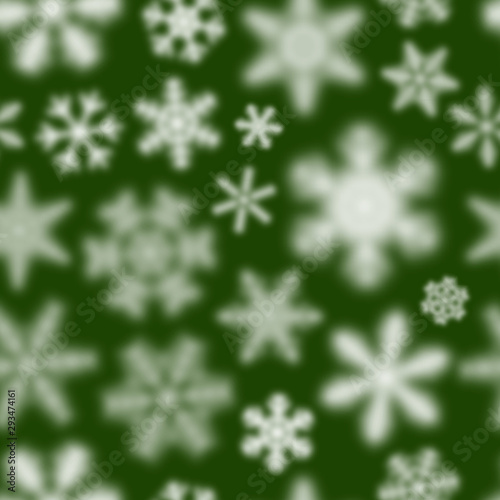 Christmas seamless pattern of white defocused snowflakes on green background