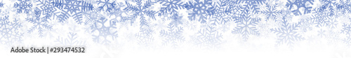 Christmas horizontal seamless banner or background of many layers of snowflakes of different shapes, sizes and transparency. Gradient from blue to white