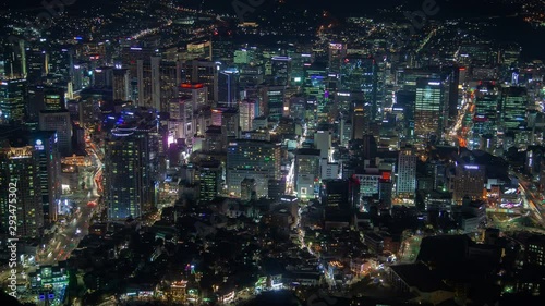 Wallpaper Mural Timelapse cars drive along Seoul main streets highways surrounded by flashing advertisement lights on buildings and skyscrapers against hill silhouettes at night zoom in Torontodigital.ca