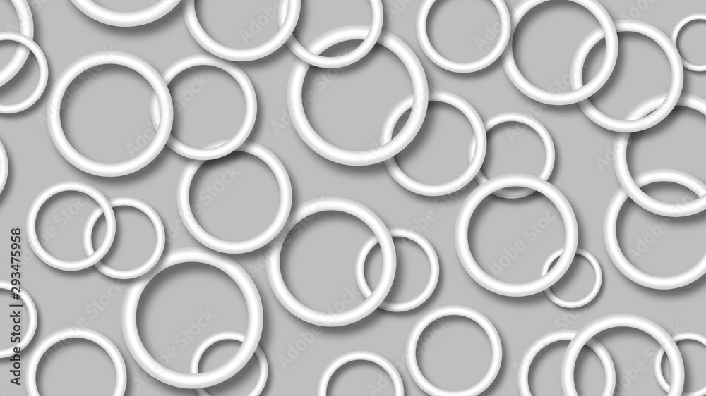 Abstract illustration of randomly arranged white rings with soft shadows on gray background