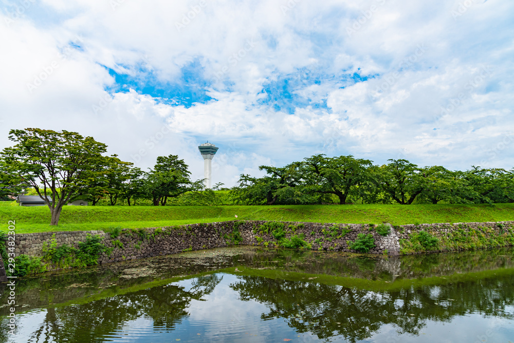 Fototapeta premium Goryokaku Tower in summer sunny day white clouds and bule sky. The tower observatory decks command the entire view of Goryokaku Park, the beautiful star shaped fort. Hakodate City, Hokkaido, Japan