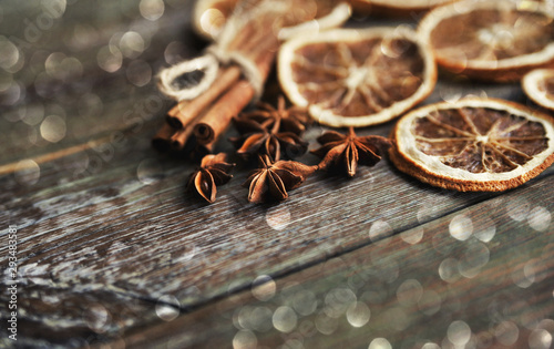 Christmas spices background. Cinnamon, dried oranges and anise on stone background.