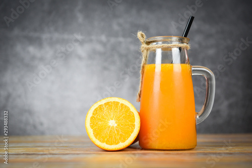 Orange juice in the glass jar and fresh orange fruit slice on wooden table  - Still life glass juice on dark background Stock Photo | Adobe Stock