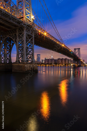 View on Williamsburg bridge From East river with Downtown Manhattan with long exposure at sunrise