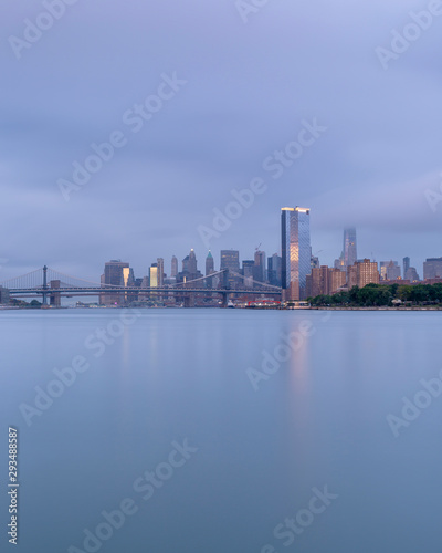 View on Financial District, Manhattan, and Brooklyn bridge.on a foggy morning from the East River.