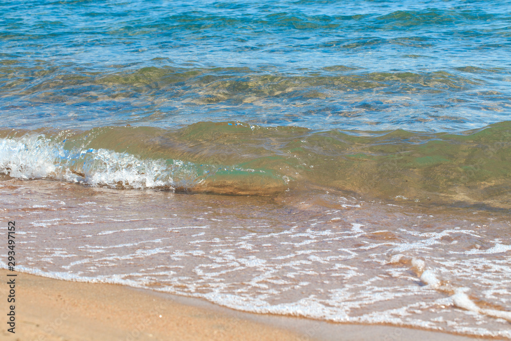 sandy beach and blue sea wave. Beautiful natural background. Tourism and travel. sandy beach and blue sea wave. Beautiful natural background. Tourism and travel.