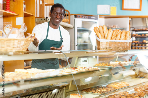 African American man offering bread and pastry