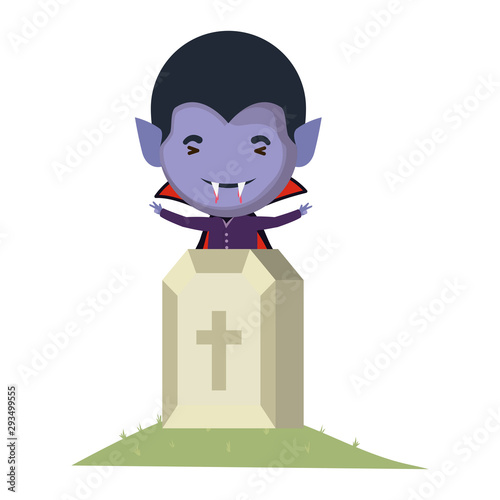cute little boy with dracula costume and graveyard