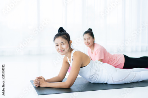 Women doing yoga exercise together, Concept of wellness, healthy life and healthy activity in every day lifestyle. Photograph with copy space.