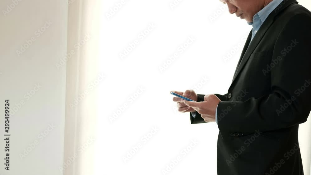 businessman standing using mobile phone. startup man working with cellphone at workplace. male entrepreneur with smartphone. businessman standing using mobile phone. startup man working with cellphone at workplace. male entrepreneur with smartphone.