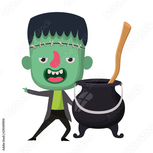 cute little boy with frankenstein costume and witch cauldron photo