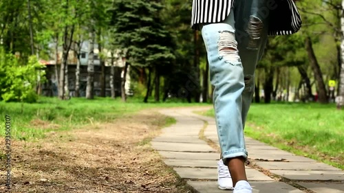 video close-up female legs walk in the park