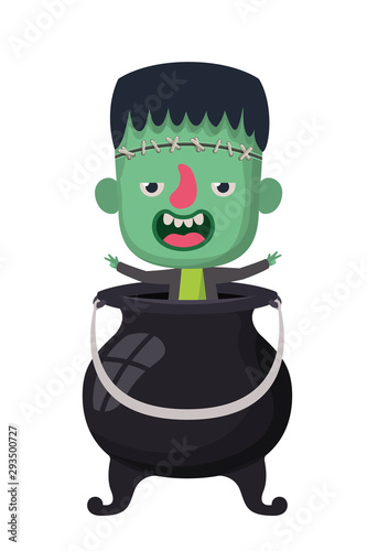 cute little boy with frankenstein costume and witch cauldron photo