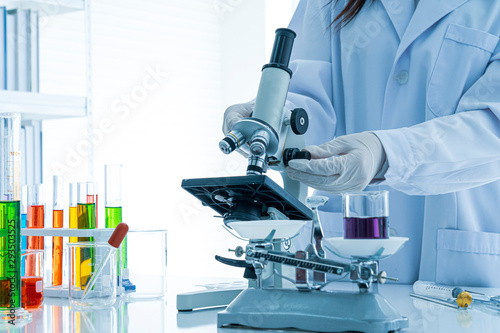 Experienced female scientist is working in laboratory.