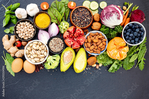 Ingredients for the healthy foods selection. The concept of healthy food set up on dark stone background.