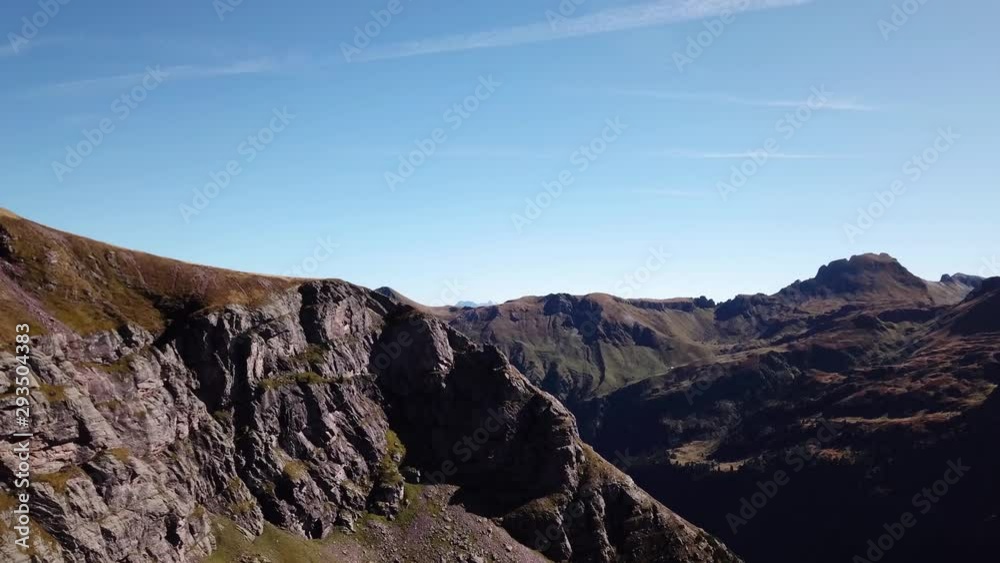 Drone flight over reddish mountain peak to view a mountain landscape Drone flight over reddish mountain peak to view a mountain landscape