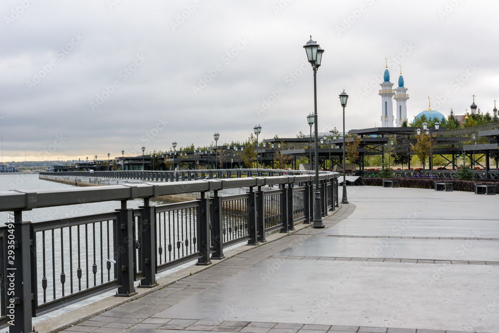 Kremlin Embankment in Kazan in cloudy day. The embankment Kazanka River. Smooth asphalt, bicycle lines, roller-skate, walking, pedestrian paths.