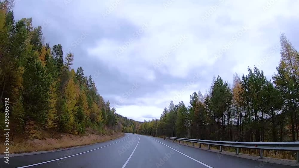 driving a car on an autumn road, traffic in lanes on a background of mountains, forests driving a car on an autumn road, traffic in lanes on a background of mountains, forests