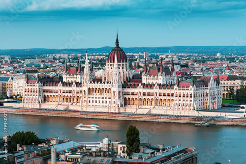 Hungarian Parliament in Budapest buy the Danube river at sunset