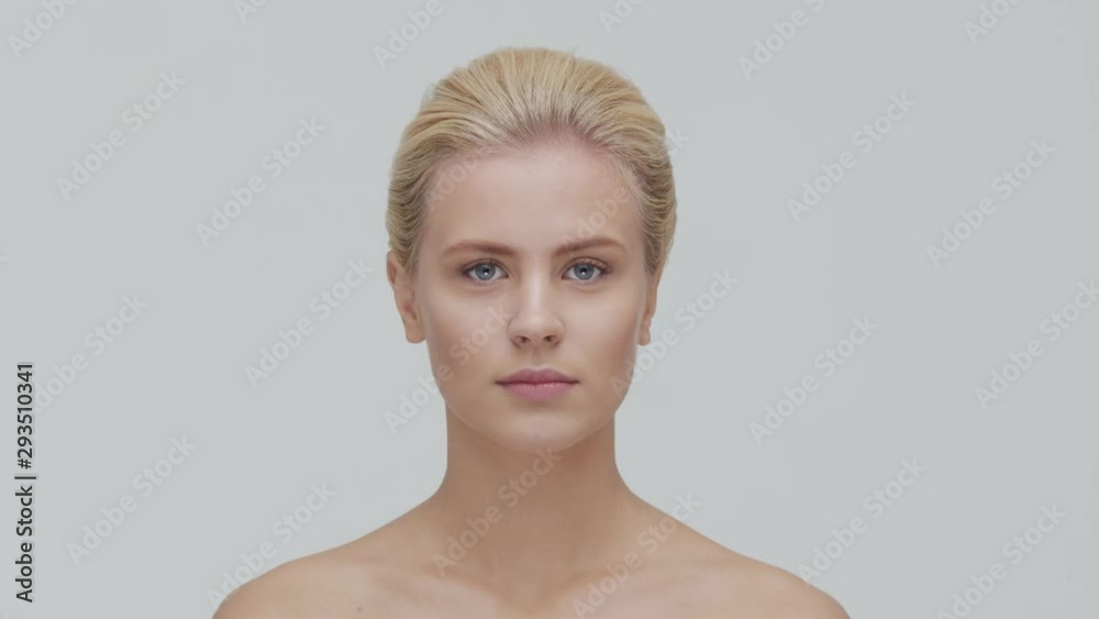 Studio portrait of young, beautiful and natural blond woman applying skin care cream. Face lifting, cosmetics and make-up. Studio portrait of young, beautiful and natural blond woman applying skin care cream. Face lifting, cosmetics and make-up.