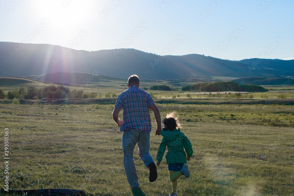 dad plays catch-up with daughter at sunset dad plays catch-up with daughter at sunset