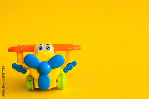 Toy plane isolated on a yellow background.
