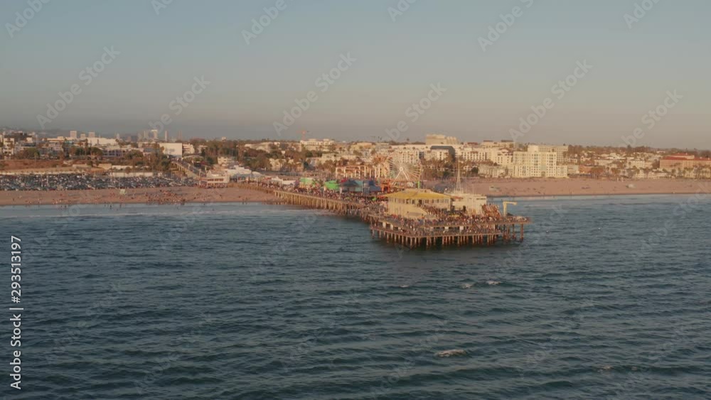 A trucking drone shot of the Santa Monica Pier and the beach. A trucking drone shot of the Santa Monica Pier and the beach.
