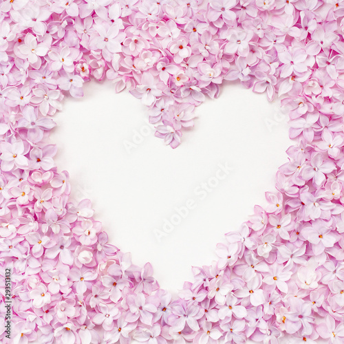 Lilac flowerheads heart shape frame. Floral beautiful border with copyspace.