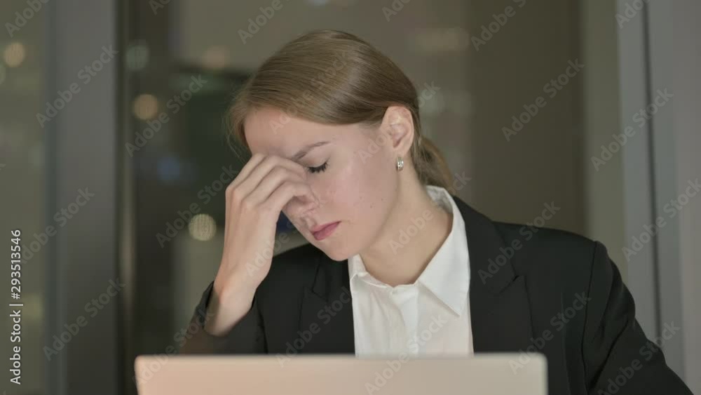 Close Up of Tired Businesswoman having Headache in Office at Night Close Up of Tired Businesswoman having Headache in Office at Night