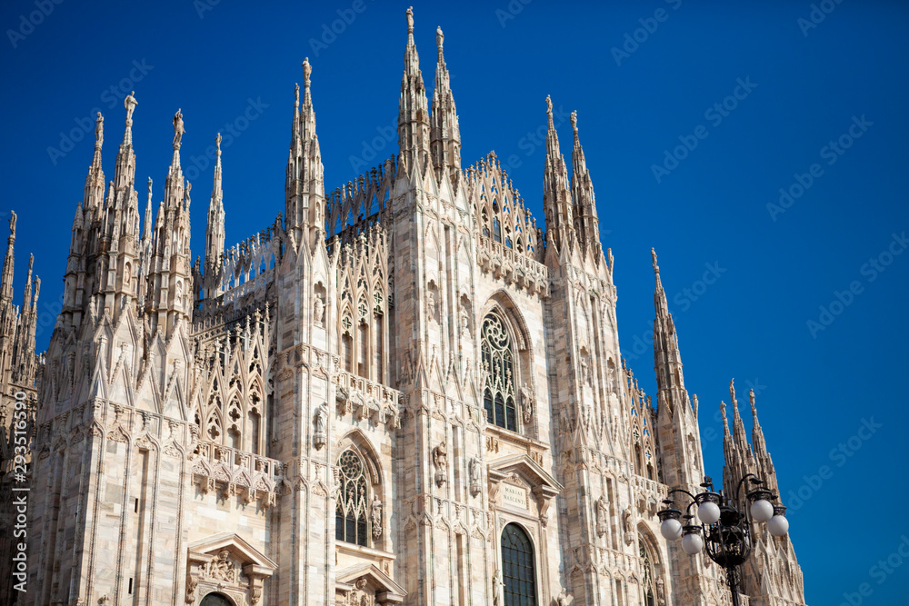 Duomo Di Milano - Cathedral (catholic church) is one of the world's largest building in the country. Close-up view of  marble details and statues on the exterior building. Milan, Lombardy, Italy.