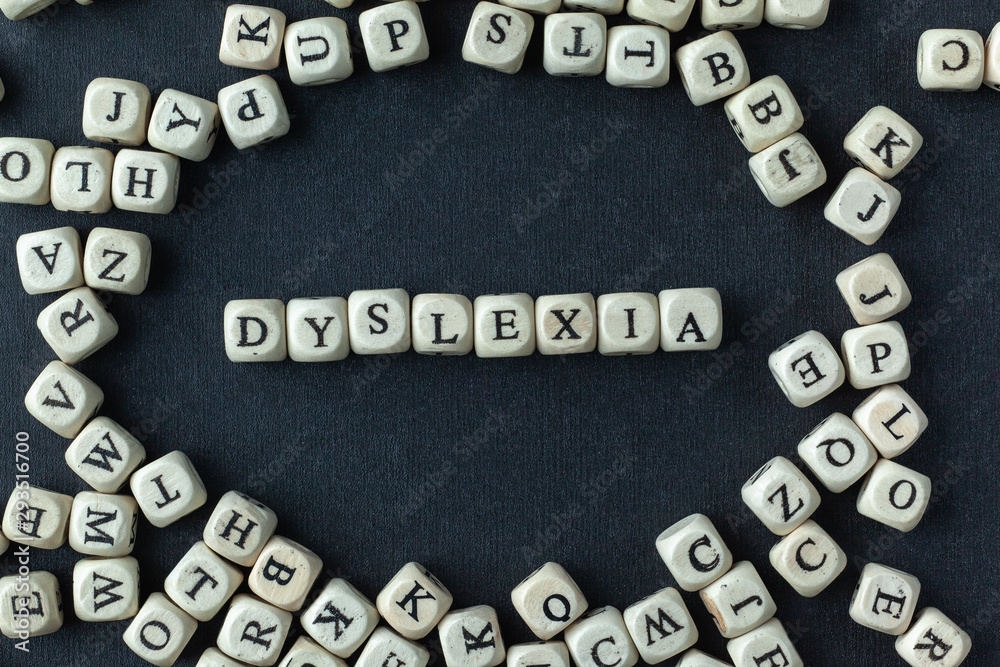Dyslexia concept, word spelled out in wooden letters on black background Dyslexia concept, word spelled out in wooden letters on black background